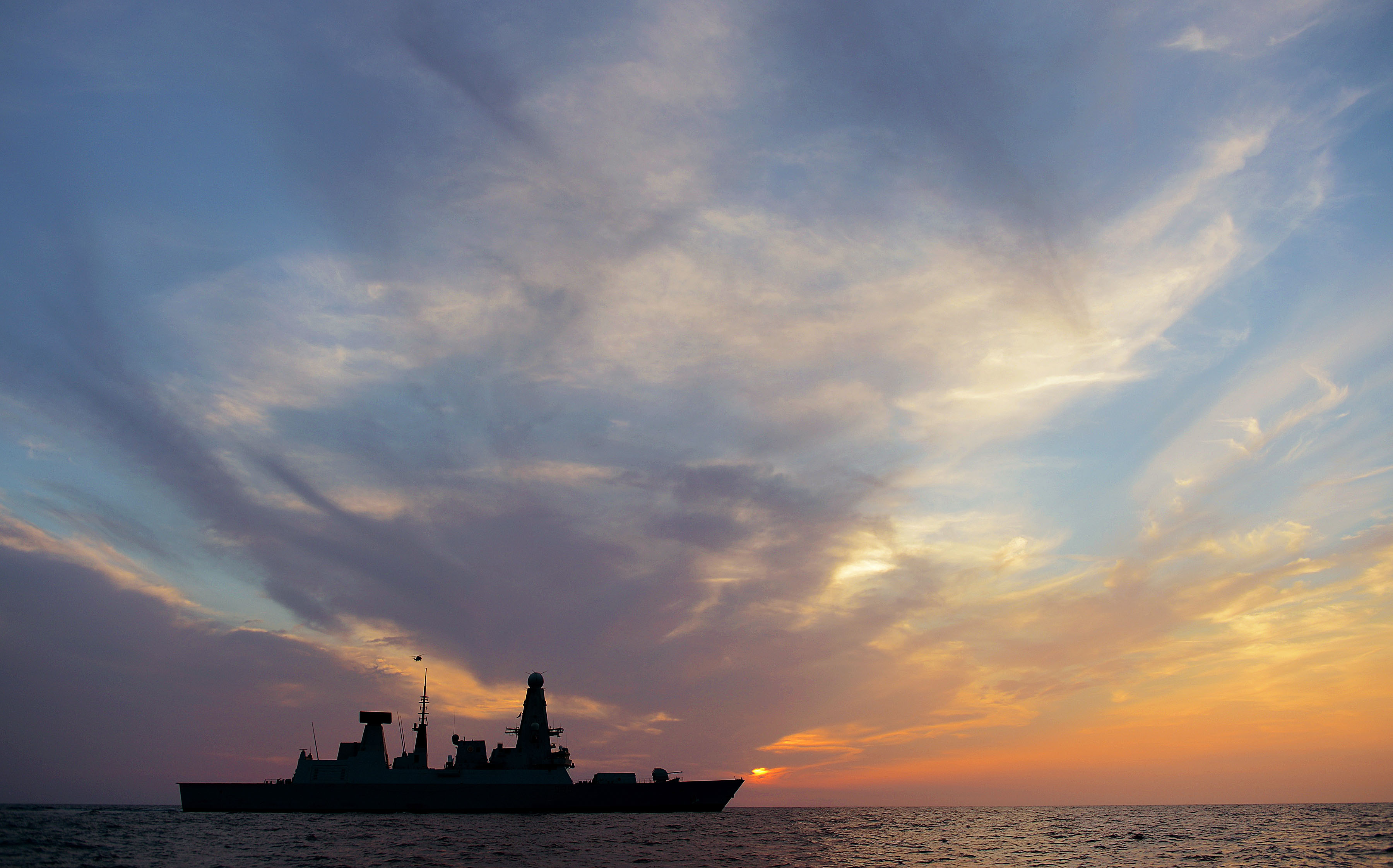 HMS Dragon crossing the setting sun during operations in the Middle East – L(Phot) Dave Jenkins via Defence Imagery