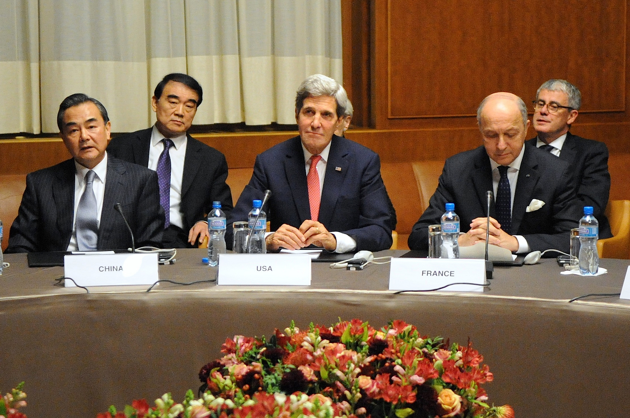 U.S. Secretary of State John Kerry sits between Chinese Foreign Minister Wang Yi and French Foreign Minister Laurent Fabius at the United Nations Headquarters after the P5+1 member nations concluded a nuclear deal with Iran in Geneva, Switzerland, on November 24, 2013 via Flickr Commons